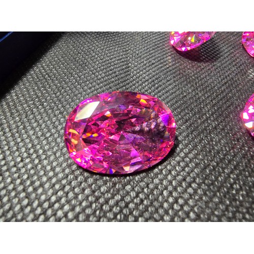 233 - A large collection of 6x large pink faceted crystal glass stones which are imitation sapphires. The ... 