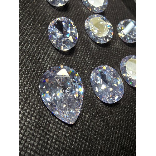 234 - A large collection of 10x large faceted crystal glass stones which are imitation sapphires. To inclu... 
