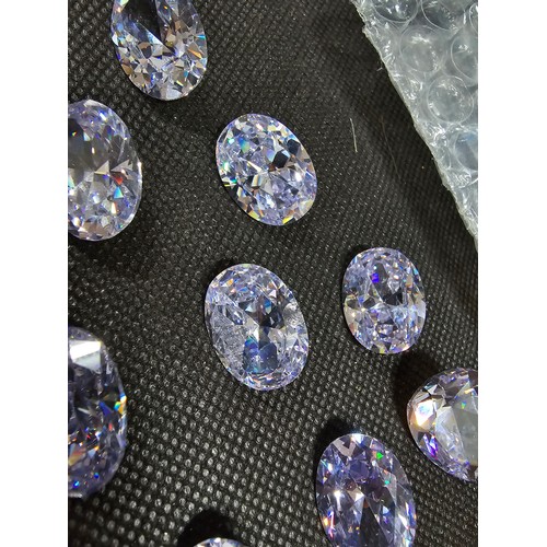 234 - A large collection of 10x large faceted crystal glass stones which are imitation sapphires. To inclu... 
