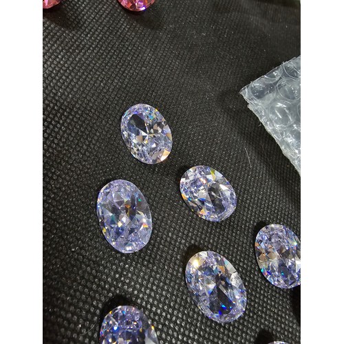 234 - A large collection of 10x large faceted crystal glass stones which are imitation sapphires. To inclu... 