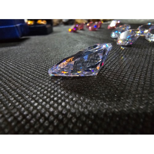234 - A large collection of 10x large faceted crystal glass stones which are imitation sapphires. To inclu... 