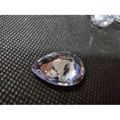 234 - A large collection of 10x large faceted crystal glass stones which are imitation sapphires. To inclu... 