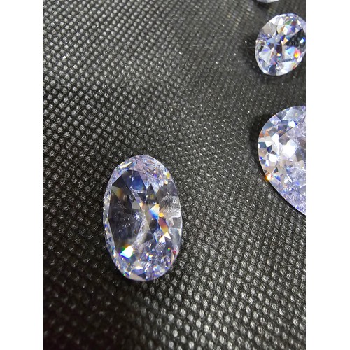 234 - A large collection of 10x large faceted crystal glass stones which are imitation sapphires. To inclu... 