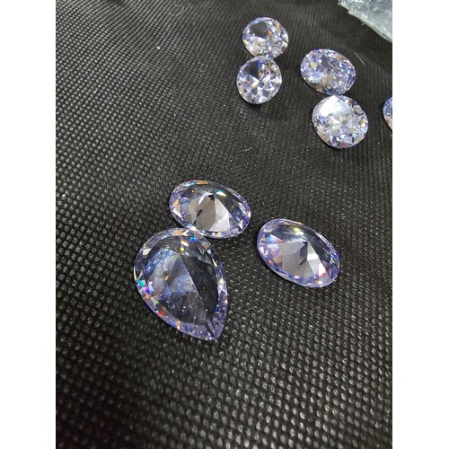 234 - A large collection of 10x large faceted crystal glass stones which are imitation sapphires. To inclu... 