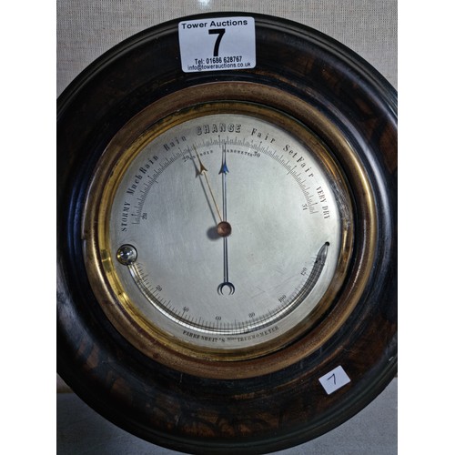 7 - A good early antique aneroid barometer featuring a good turned solid wood case presenting an excelle... 