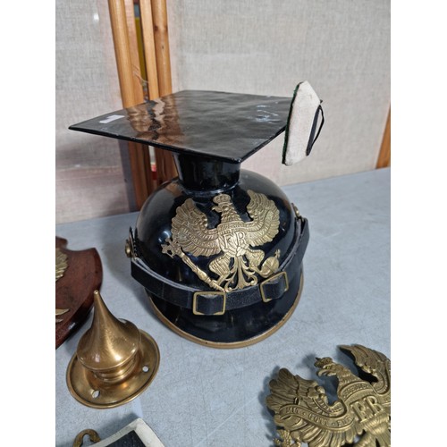 9 - A good collection of of Prussian military items inc a shield with a Prussian military Picklehaube br... 