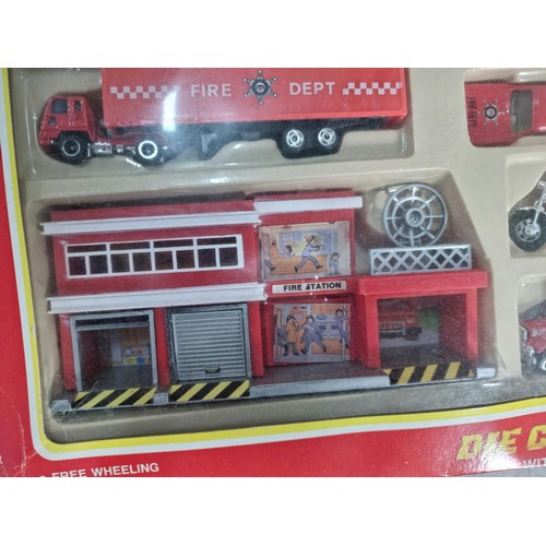 26 - A diecast model fire engine scene, vintage set, never been opened.