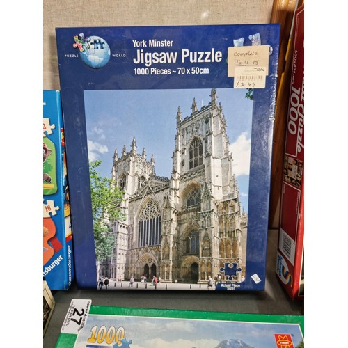 27 - A quantity of 9 jigsaw puzzles including a 1000 piece puzzle, see photos for subjects