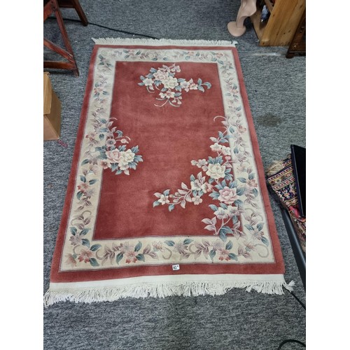 437 - Good quality thick floral hand made rug 100% pure wool pile in a deep coral/ cream colour. Handmade ... 