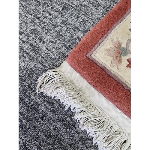 437 - Good quality thick floral hand made rug 100% pure wool pile in a deep coral/ cream colour. Handmade ... 