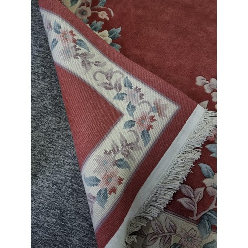 437 - Good quality thick floral hand made rug 100% pure wool pile in a deep coral/ cream colour. Handmade ... 