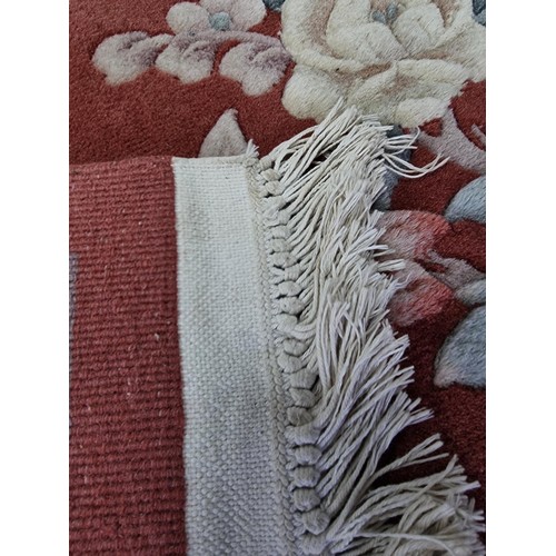 437 - Good quality thick floral hand made rug 100% pure wool pile in a deep coral/ cream colour. Handmade ... 