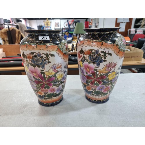 23 - Pair of tall hand decorated ceramic vases with floral design both in good order with no chips or cra... 