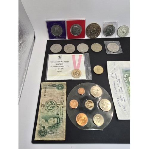 269A - A collection of various British coins which includes 2x one pound notes, 2x two pound coins, a Five ... 