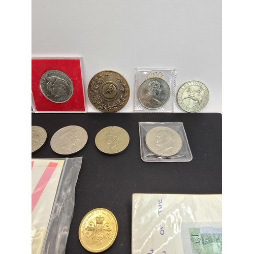 269A - A collection of various British coins which includes 2x one pound notes, 2x two pound coins, a Five ... 