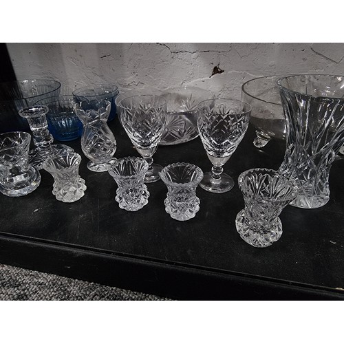 18 - Shelf containing a large quantity of cut glass crystal glassware inc crystal cut vases, blue glass s... 