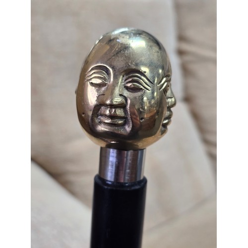 47 - A Good quality brass Buddha topped walking stick with 4 different expressions to each side (4 noble ... 