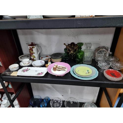 16A - A shelf full of collectables including 3 decanters, 1 in a diced design, a sundae dish set, a salt a... 