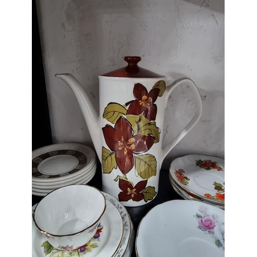 16A - A shelf full of collectables including 3 decanters, 1 in a diced design, a sundae dish set, a salt a... 