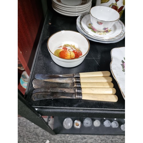 16A - A shelf full of collectables including 3 decanters, 1 in a diced design, a sundae dish set, a salt a... 