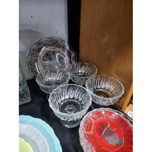 16A - A shelf full of collectables including 3 decanters, 1 in a diced design, a sundae dish set, a salt a... 