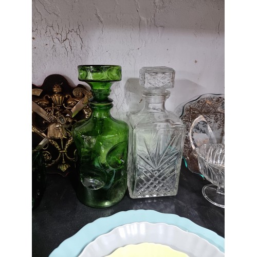 16A - A shelf full of collectables including 3 decanters, 1 in a diced design, a sundae dish set, a salt a... 