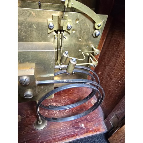 46 - A good quality antique oak mantel clock featuring an 8 day movement striking with a ting tang double... 