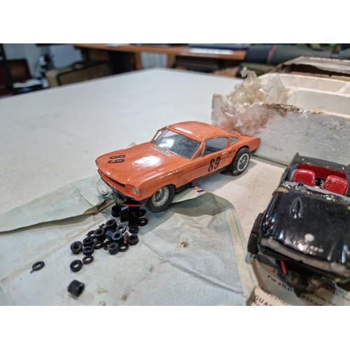 63 - Collection of slot car racing cars along with two boxes for slot cars inc a Revell model racer sting... 