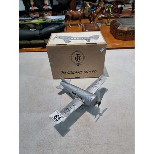 65 - Boxed tin plate reproduction of a clock work plane with fold back wings, based on a plane from 1927,... 