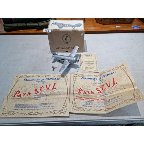 65 - Boxed tin plate reproduction of a clock work plane with fold back wings, based on a plane from 1927,... 