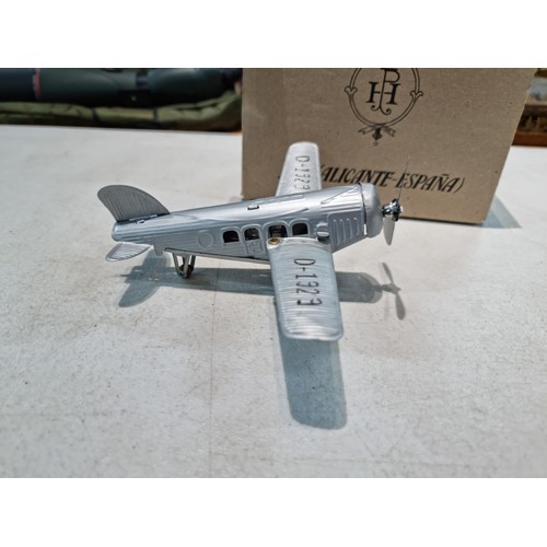 65 - Boxed tin plate reproduction of a clock work plane with fold back wings, based on a plane from 1927,... 
