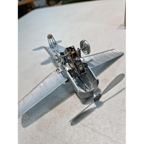 65 - Boxed tin plate reproduction of a clock work plane with fold back wings, based on a plane from 1927,... 