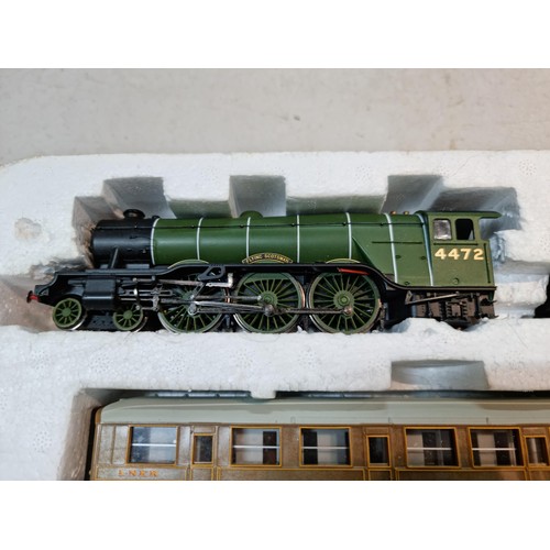 87 - Box containing a Flying Scotsman LNER 4772 locomotive and tender, spares and repair loose wire, 3 LN... 