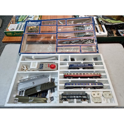 88 - Boxed Lima HO 1/87 electric train tack set, comes with an electric engine two coaches, power unit an... 