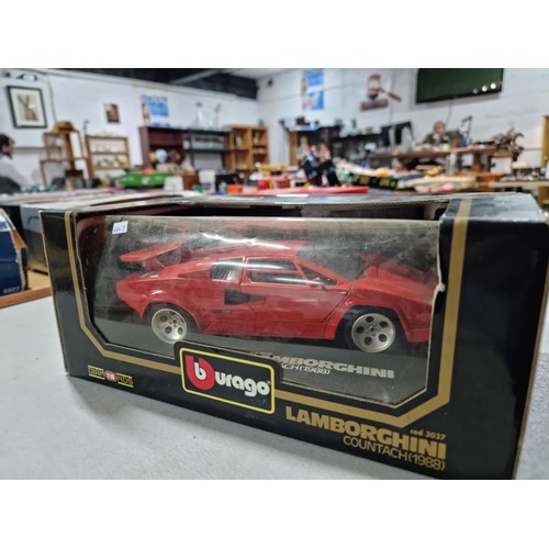 102 - A collection of 2 diecast boxed cars including a Burago Ferrari GTO 1984 on a wooden plinth along wi... 