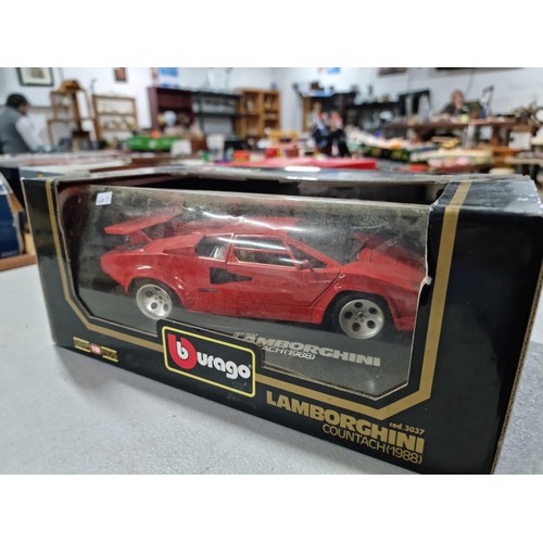 102 - A collection of 2 diecast boxed cars including a Burago Ferrari GTO 1984 on a wooden plinth along wi... 