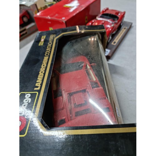 102 - A collection of 2 diecast boxed cars including a Burago Ferrari GTO 1984 on a wooden plinth along wi... 