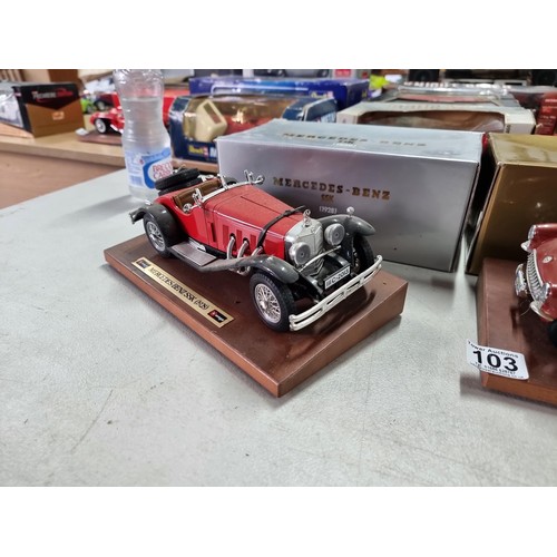 103 - 2 boxed Burago diecast cars on wooden plinths including a Mercedes Benz SSK 1928 and a Chevrolet Cor... 
