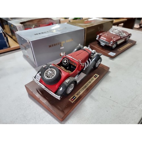 103 - 2 boxed Burago diecast cars on wooden plinths including a Mercedes Benz SSK 1928 and a Chevrolet Cor... 