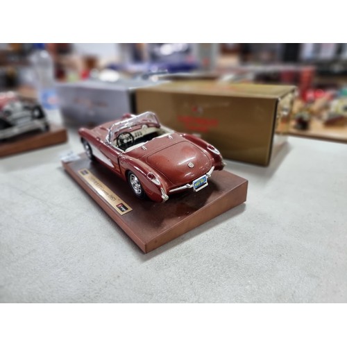 103 - 2 boxed Burago diecast cars on wooden plinths including a Mercedes Benz SSK 1928 and a Chevrolet Cor... 