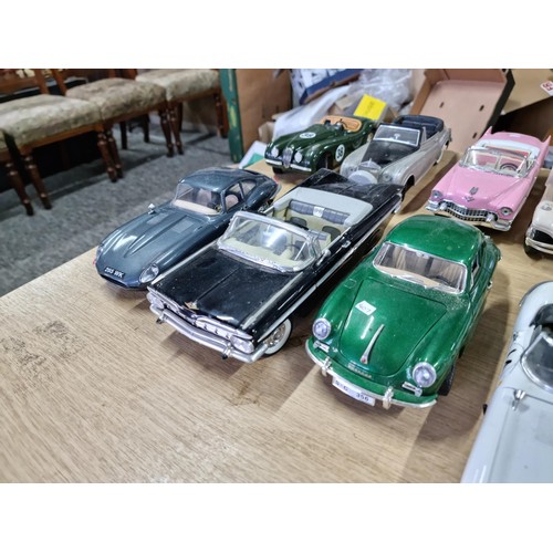 106 - A collection of 12 unboxed diecast cars including a Burago Giugiaro, a Maisto Cadillac 1959, a Burag... 