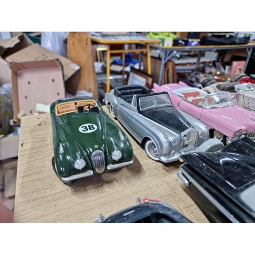 106 - A collection of 12 unboxed diecast cars including a Burago Giugiaro, a Maisto Cadillac 1959, a Burag... 