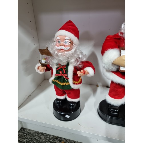 5 - Collection of Christmas items inc 2x musical Father Christmas figures, and 2x decorative bottle hold... 