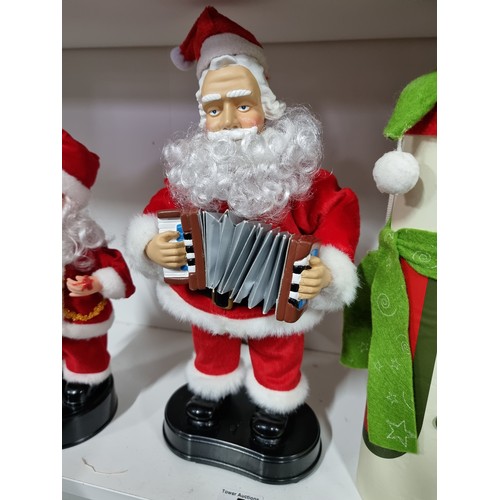 5 - Collection of Christmas items inc 2x musical Father Christmas figures, and 2x decorative bottle hold... 