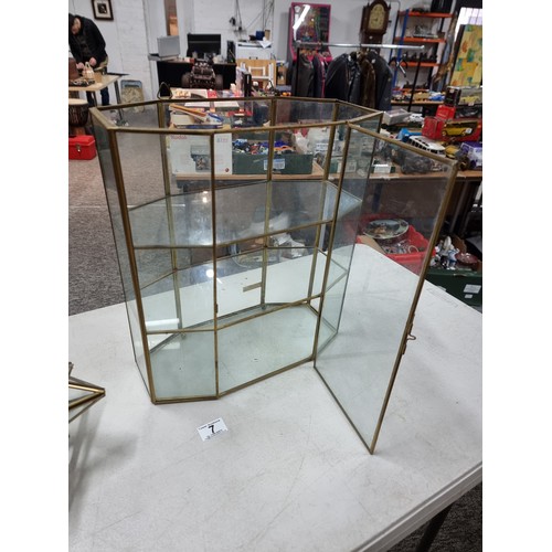 7 - A three shelf glass display cabinet in good order with two shelves inside and brass edging, along wi... 