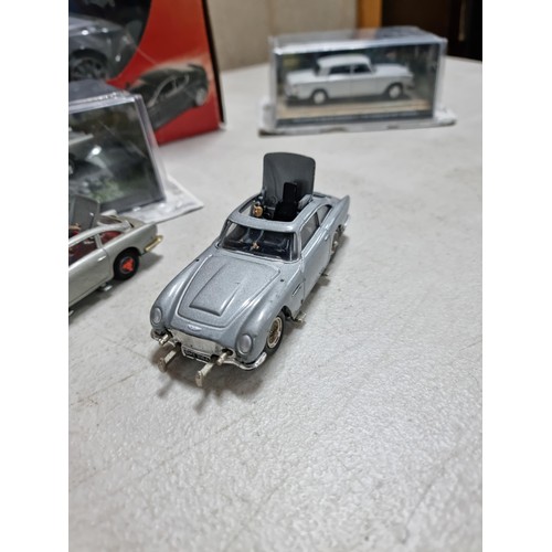 68 - A collection of James Bond related diecast vehicles to include 2x loose Corgi Aston Martin DB5's of ... 