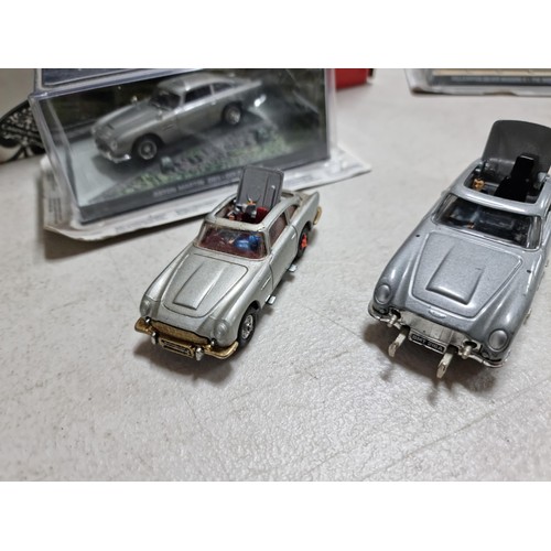 68 - A collection of James Bond related diecast vehicles to include 2x loose Corgi Aston Martin DB5's of ... 