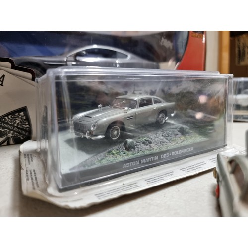 68 - A collection of James Bond related diecast vehicles to include 2x loose Corgi Aston Martin DB5's of ... 