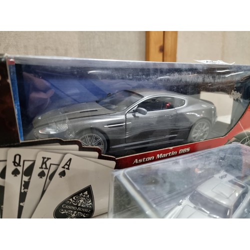 68 - A collection of James Bond related diecast vehicles to include 2x loose Corgi Aston Martin DB5's of ... 