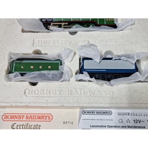 96 - A comprehensive boxed as new Hornby Flying Scotsman locomotive set R098 and R089 to include a flying... 